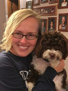 Blonde woman holding brown and white dog